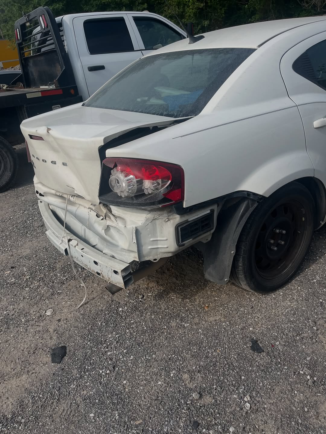 Dodge Avenger before repair — rear quarter panel damage and bumper detail