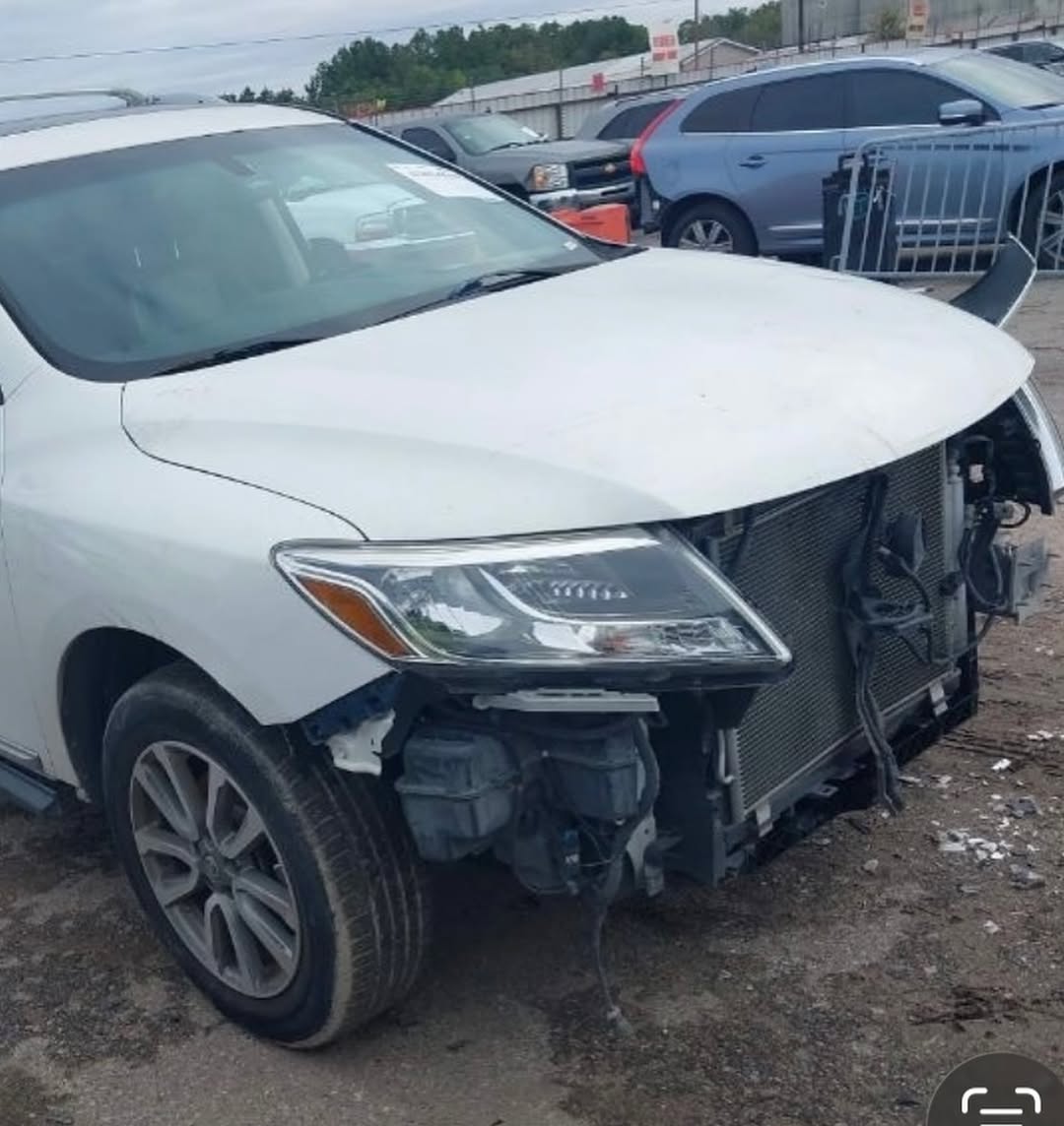 Nissan Pathfinder before repair — front end destroyed, radiator and frame exposed