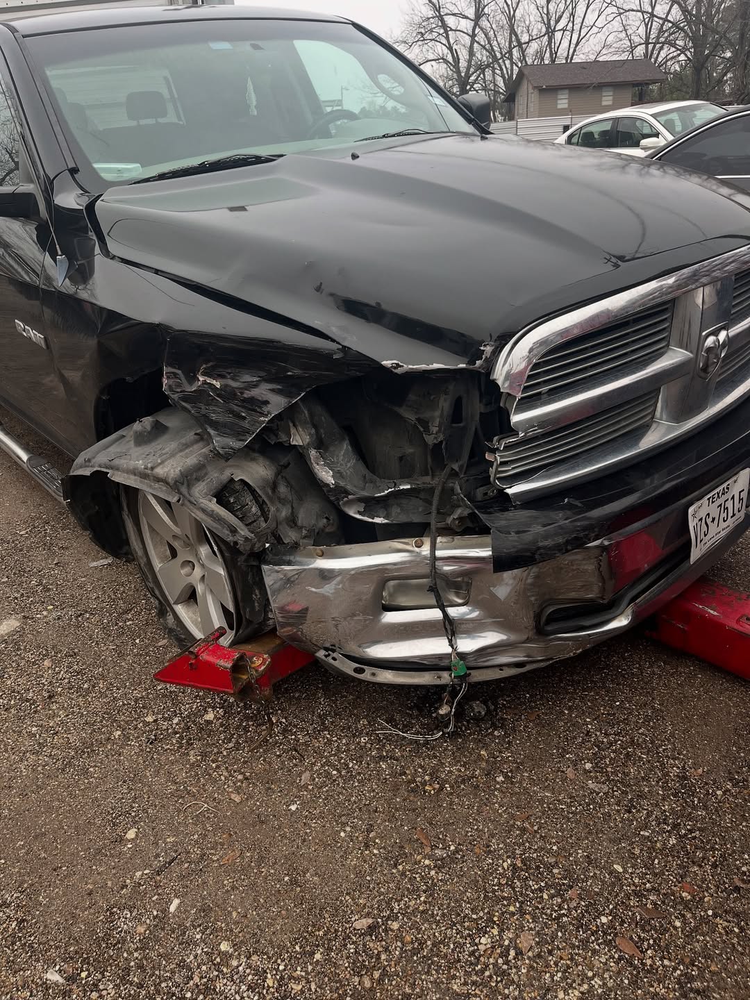 Dodge Ram 1500 before repair — crushed front left fender and bumper damage