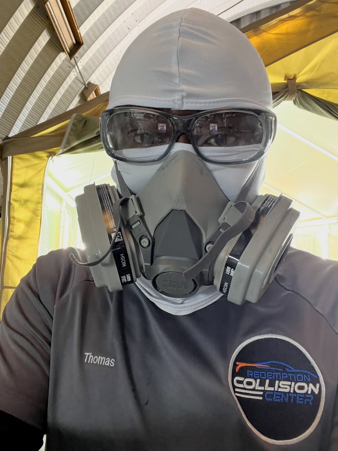 Thomas suiting up in the paint booth — Redemption Collision Center Humble TX